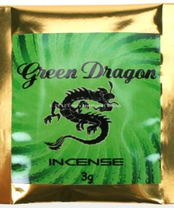 Burning Green Dragon Herbal Incense stick in ceramic holder