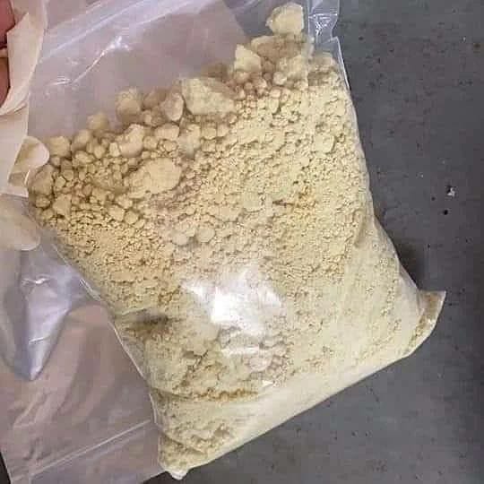 K2 powder synthetic cannabinoid close-up with warning label